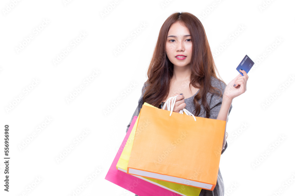 Happy asian woman holding shopping bags and credit card. Beautiful charming woman with many shopping bags brand name product that shop has discount isolated on white background. Copy space. Happy asian woman holding shopping bags and credit card. Beautiful charming woman with many shopping bags brand name product that shop has discount isolated on white background. Copy space.