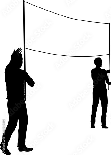 Two protestors or demonstrators at a demonstration march, picket line or strike protest rally in silhouette. Holding up a banner sign.