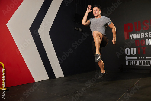 sportsman jumping up and training in the gym