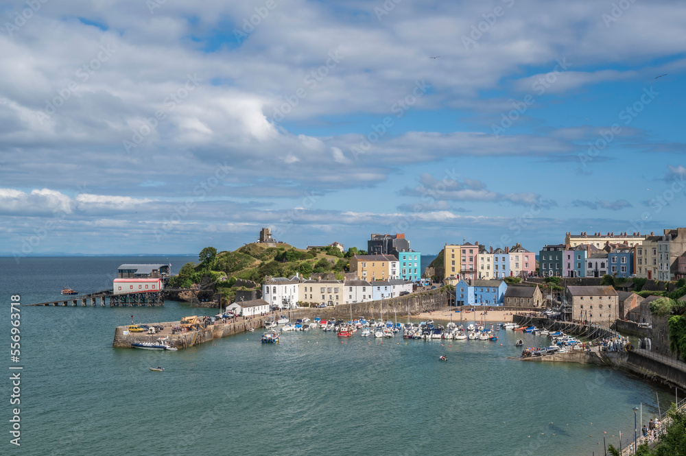 Tenby harbour. A coastal resort in Pembrokeshire, south Wales. Colourful buildings overlook the harbour, on a sunny, summers day.