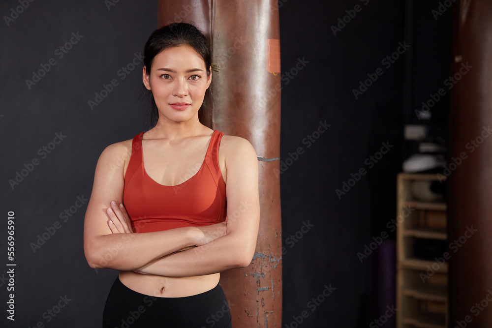 portrait female personal trainer smiling and crossed arms pose in the gym portrait female personal trainer smiling and crossed arms pose in the gym