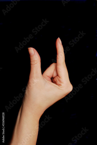 female hand gesture of picking or measuring a distance