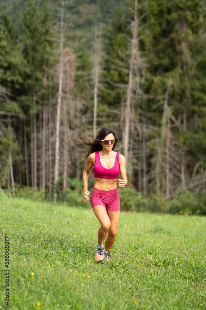 Trail running smiling girl runs uphill and on trail Trail running smiling girl runs uphill and on trail