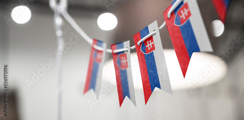 Photography A garland of Slovakia national flags on an abstract blurred background