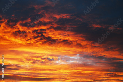 Dramatic sky. Red sunset with dark clouds. © Victor