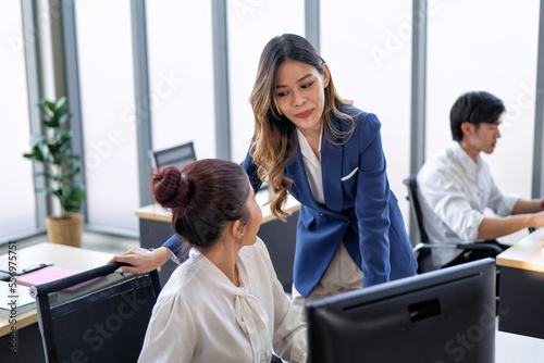 Business employee in formal suits working at table and discussing business strategy together