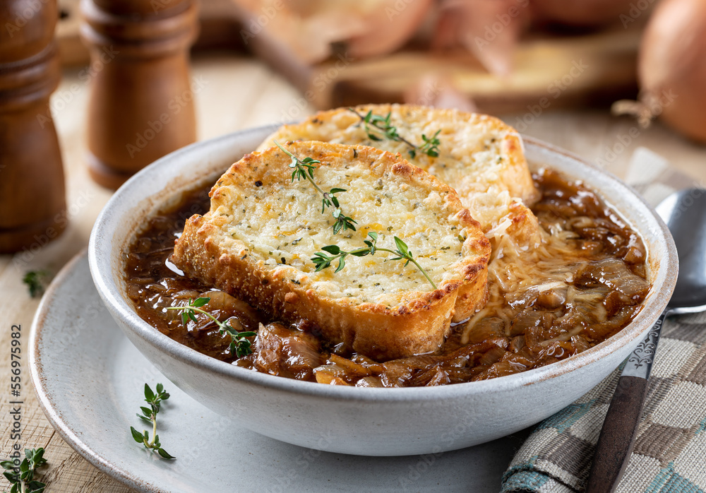 French onion soup with toasted cheese baguette garnished with thyme French onion soup with toasted cheese baguette garnished with thyme