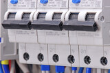 circuit breakers for protection of electrical loads installed in the electrical panel. Soft focus.