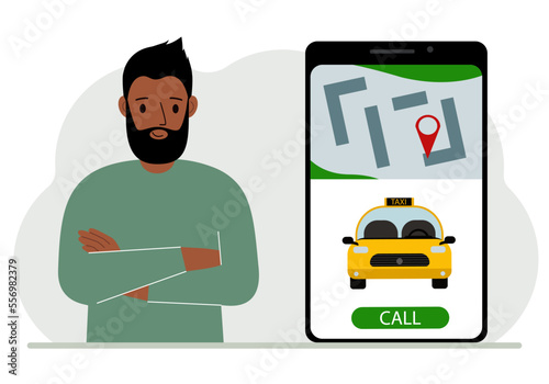 A man next to a large smartphone on the screen which has a taxi and geolocation. The concept of a mobile taxi application or ordering a taxi online.