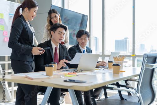 A group of young Asian businessmen Talking and planning work happily and have fun. at the company's office