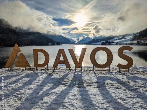 Davos Klosters Mountains. View of Lake Davos with snow. Strolling around this beautiful mountain lake in the sunshine. High quality photo