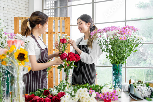 group of female florists Asians are arranging flowers for customers who come to order them for various ceremonies such as weddings, Valentine's Day or to give to loved ones.