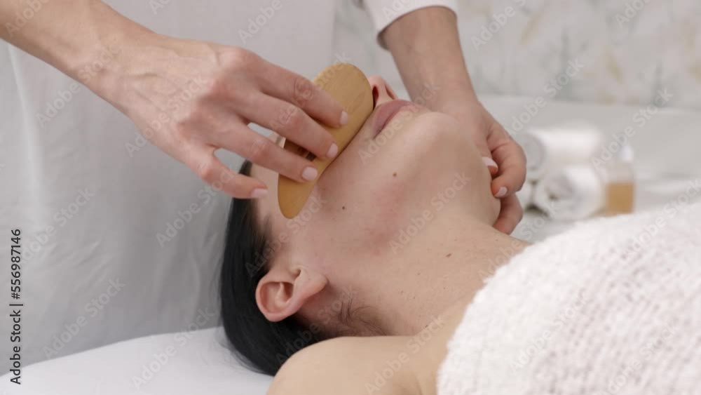 Facial massage for young woman. Relaxing technique at the spa. Facial massage for young woman. Relaxing technique at the spa.