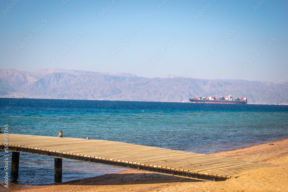Dock pier on the Red Sea near Aqaba, exotic beach dock pier, travel and tourism concept 