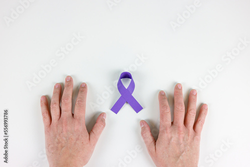 World cancer day, woman's hands on white background and purple ribbon
