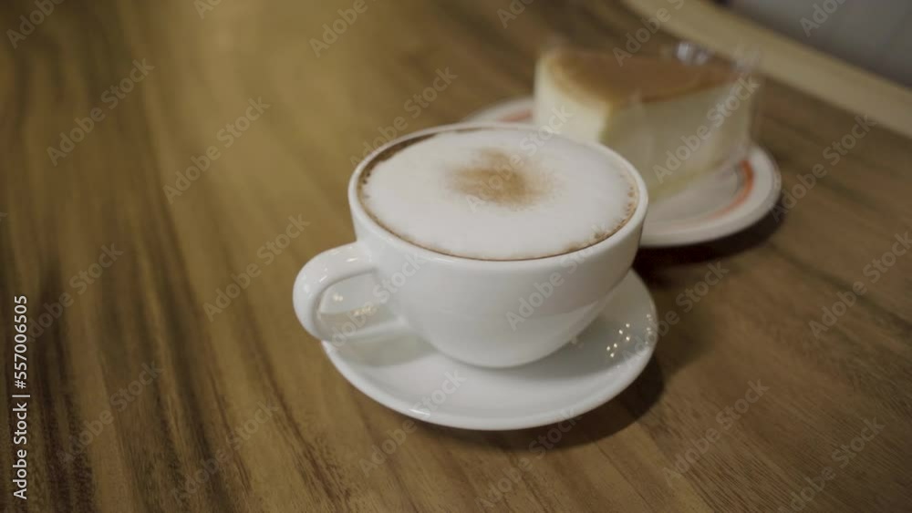 Cheese slice cake and cappuccino in a mug. Cheese slice cake and cappuccino in a mug.