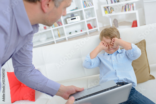 Child crying as man takes away laptop