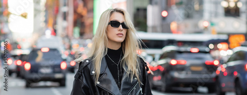 stylish young woman in leather jacket and sunglasses posing on street of New York, banner