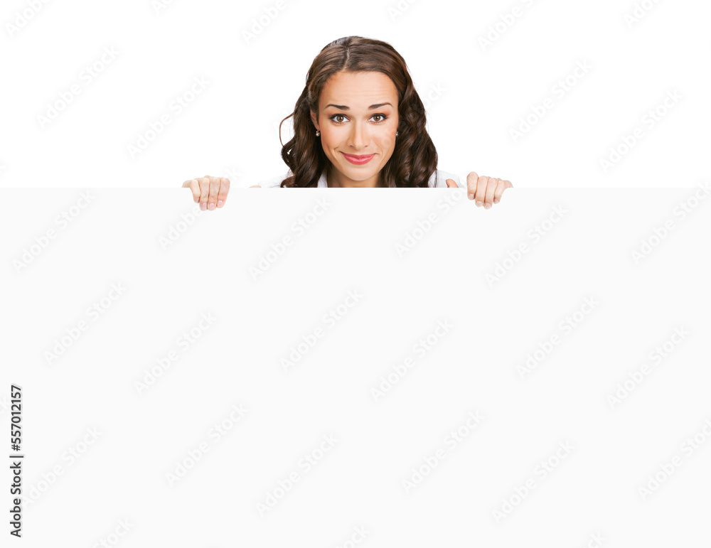Cheerful smiling brunette woman standing behind, peeping from blank banner or mock up signboard, showing advertising copy space ad text area, isolated on white background. Cheerful smiling brunette woman standing behind, peeping from blank banner or mock up signboard, showing advertising copy space ad text area, isolated on white background.