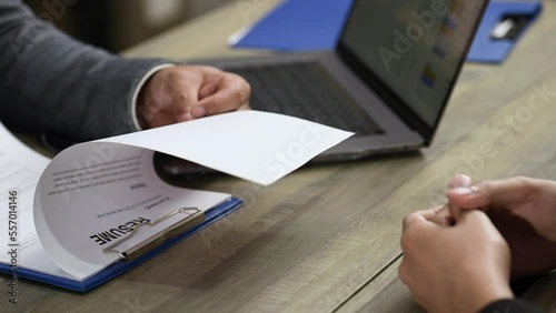 HR manager interview and listen to applicant candidate answer.He reading a resume during a job interview, employment  recruitment concept.Job application company is accepting employees from interview.