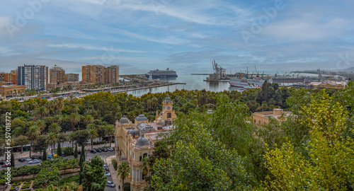 Amazing panorama of Malaga city center, seaport and marina on a beautiful sunny day with blue sky above. Scenic view of the Malaga from the Alcazaba citadel located on the hills. Andalusia, Spain.