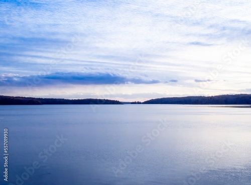 Beautiful calm river and cloudy blue sky  late afternoon. Winter on the Damariscotta River  Maine.  A popular tourist spot  Damariscotta is the Oyster Capital of New England.