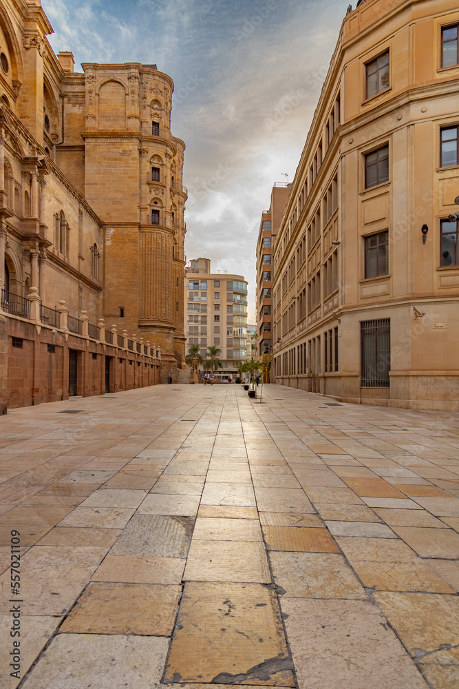 Malaga empty streets at early morning. Catedral de Malaga, Empty streets around Malaga La Manquita Cathedral in the light of the rising autumn sun. Andalusia, Spain.           