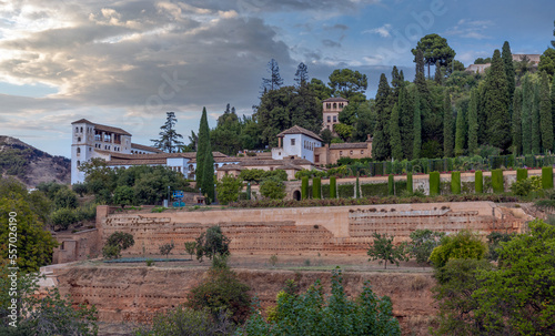 Amazing panorama of Granada city and Alhambra's Alcazaba fortress. Scenic view from Generalife gardens on a sunny day with blue sky above. Granada, Andalusia, Spain.                                   