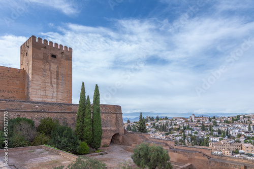 Amazing panorama of Granada city and Alhambra's Alcazaba fortress. Scenic view from Generalife gardens on a sunny day with blue sky above. Granada, Andalusia, Spain.                                   