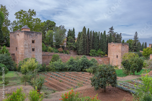 Amazing panorama of Granada city and Alhambra's Alcazaba fortress. Scenic view from Generalife gardens on a sunny day with blue sky above. Granada, Andalusia, Spain.                                   