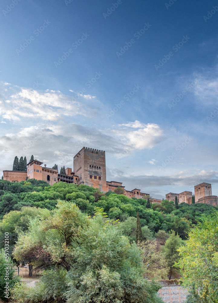 Amazing view of the Sabika hill with the ruins of the ramparts, watchtowers and Alhambra Palace  from the Carrera Del Darro street. Sunny day with an amazing sky.
