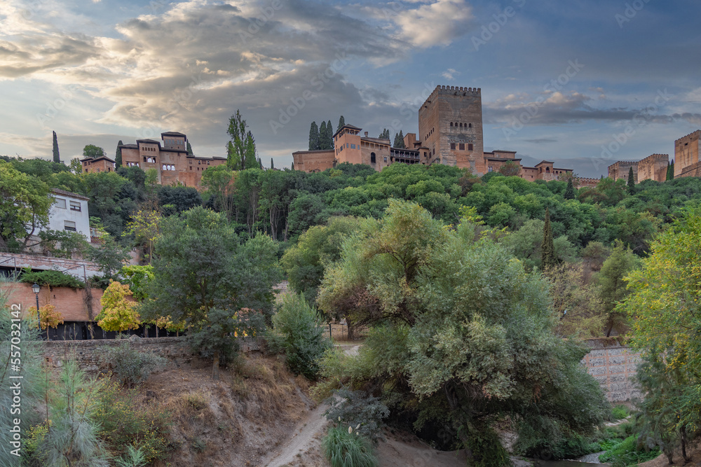 Amazing view of the Sabika hill with the ruins of the ramparts, watchtowers and Alhambra Palace  from the Carrera Del Darro street. Sunny day with an amazing sky.