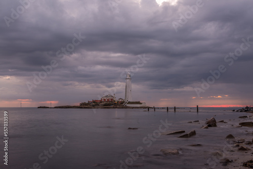 A cloudy sunrise on a grey day at St Mary's Lighthouse in Whitley Bay, England