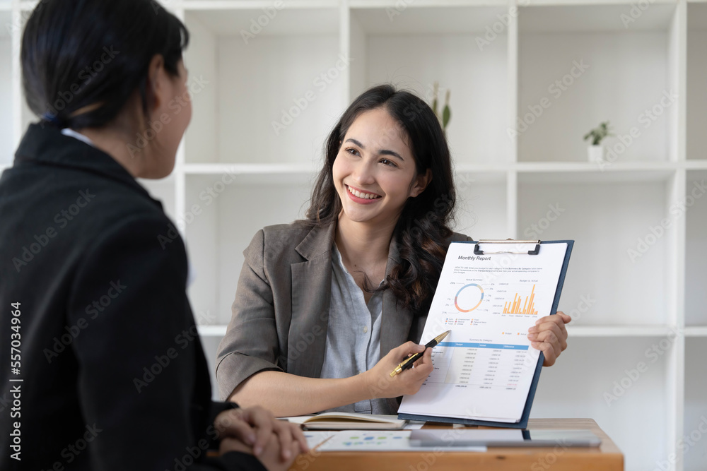 Two business leaders talk about charts, financial graphs showing results are analyzing and calculating planning strategies, business success building processes Two business leaders talk about charts, financial graphs showing results are analyzing and calculating planning strategies, business success building processes