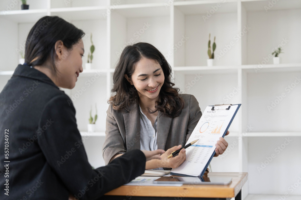Two business leaders talk about charts, financial graphs showing results are analyzing and calculating planning strategies, business success building processes Two business leaders talk about charts, financial graphs showing results are analyzing and calculating planning strategies, business success building processes
