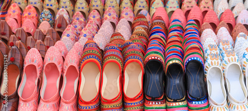Colorful hand made traditional Rajasthan style shoes up for sale at street side in Jaipur.