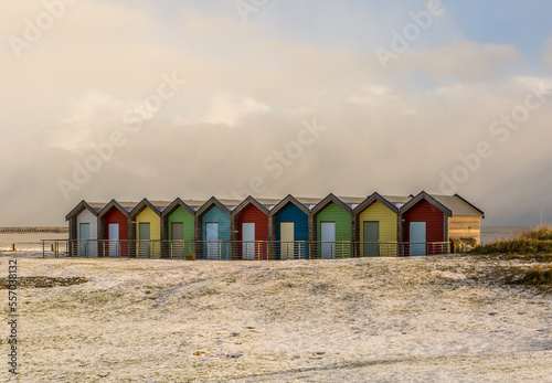 The colorful beach huts at Blyth beach surrounded by snow in a wintery Northumberland, England
