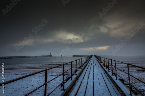A freezing, snowy morning at Blyth beach at the old wooden Pier stretching out to the North Sea