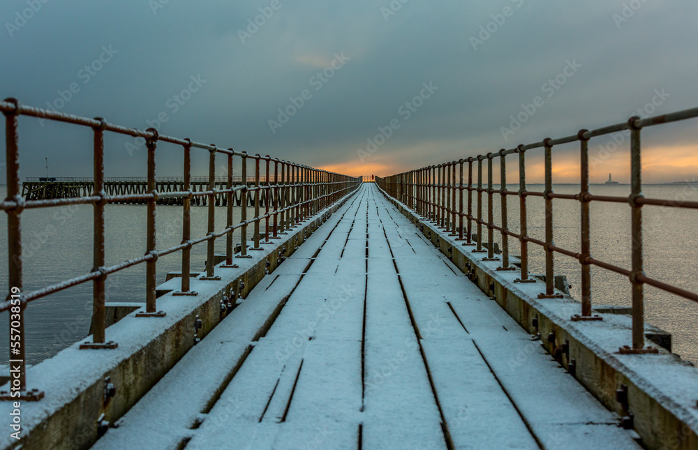 A freezing, snowy morning at Blyth beach at the old wooden Pier stretching out to the North Sea