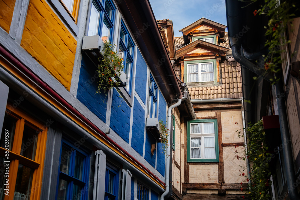 Quedlinburg, Saxony-Anhalt, Germany, 28 October 2022: Schuhhof or cobbler narrow street, Historic old vintage colored timber frame houses in medieval town, half-timbered home at sunny autumn day