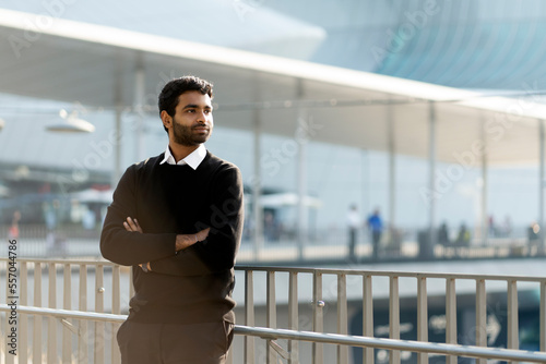Canvastavla Pensive handsome Indian businessman with arms crossed looking away standing on t