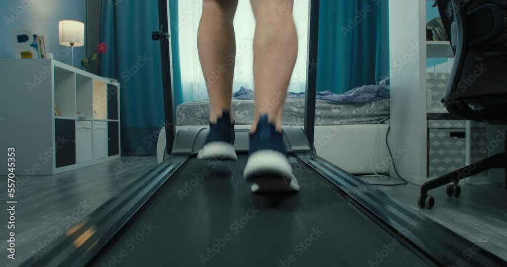 Lose weight on the treadmill, man running on treadmill in home gym