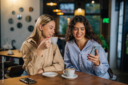 Two close friends are having coffee together