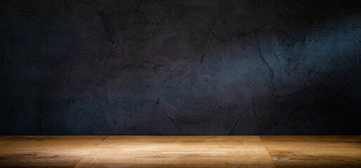 Wooden table or counter top with black stone wall background