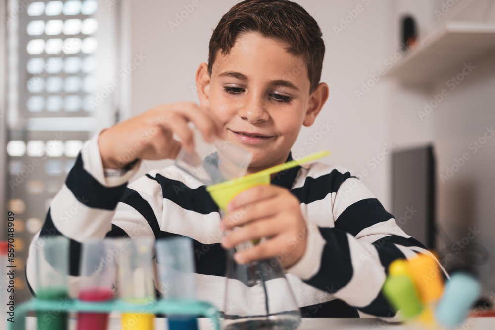 Little boy having fun with chemistry lab set. Science experiments at