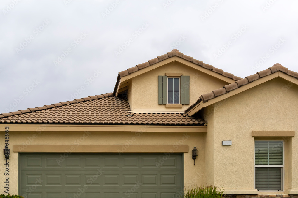 Tiled roof and attic window of a single-family residence, Menifee, California, USA