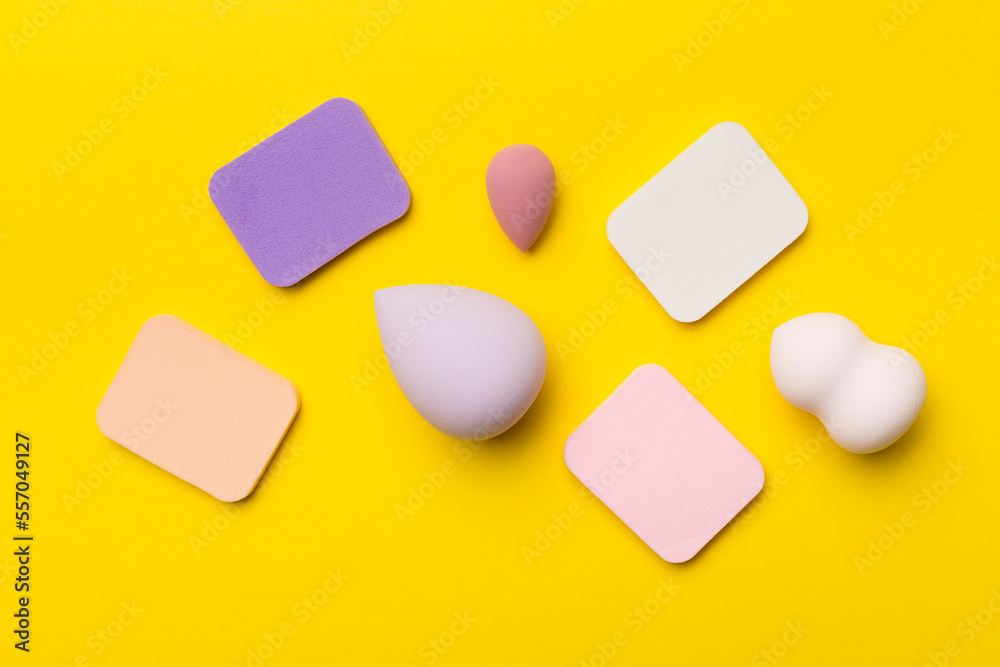 Beauty blenders on color background, top view