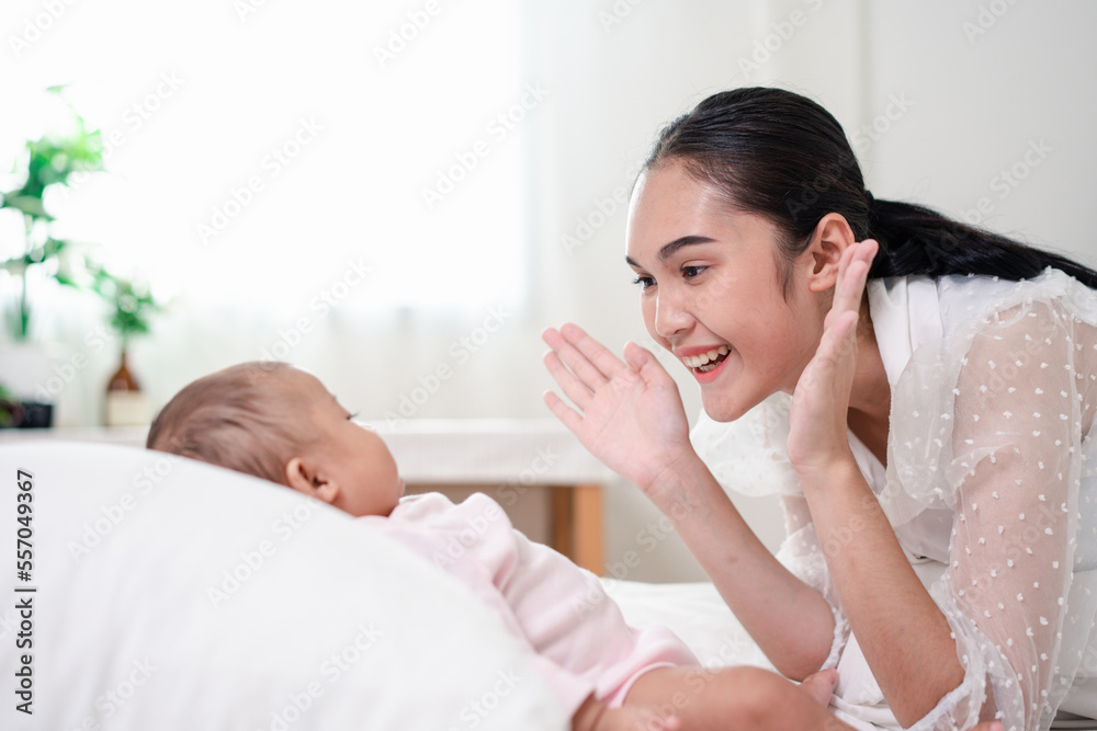 Mother Parenting and newborn birth life. Mom and baby boy playing in sunny bedroom, Family having fun together. childcare, maternity concept. Mother Parenting and newborn birth life. Mom and baby boy playing in sunny bedroom, Family having fun together. childcare, maternity concept.