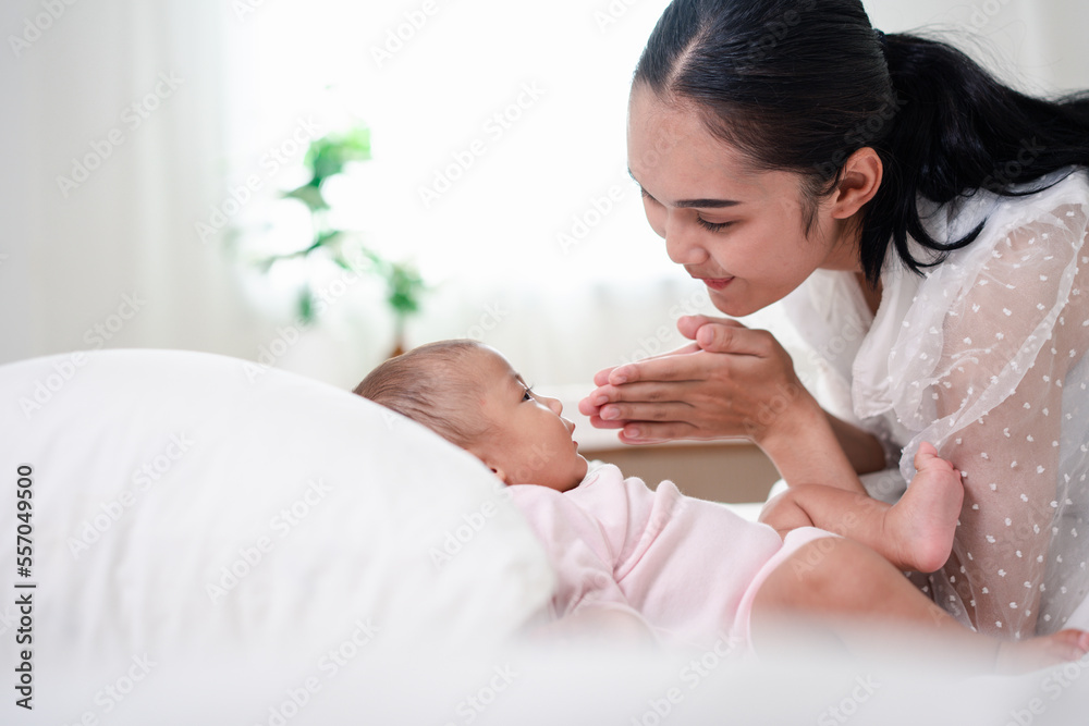 Mother Parenting and newborn birth life. Mom and baby boy playing in sunny bedroom, Family having fun together. childcare, maternity concept. Mother Parenting and newborn birth life. Mom and baby boy playing in sunny bedroom, Family having fun together. childcare, maternity concept.