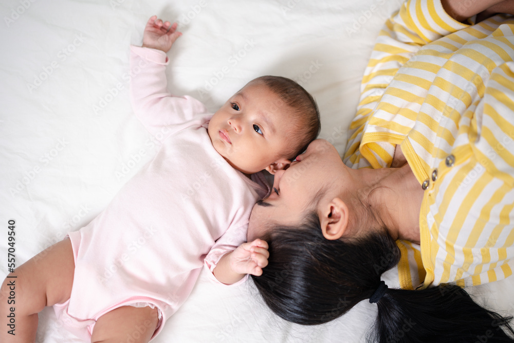 Mother Parenting and newborn birth life. Mom and baby boy playing in sunny bedroom, Family having fun together. childcare, maternity concept. Mother Parenting and newborn birth life. Mom and baby boy playing in sunny bedroom, Family having fun together. childcare, maternity concept.